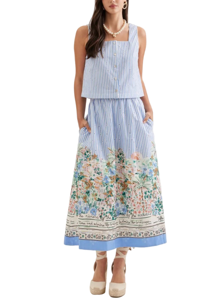 Striped sleeveless top featuring square neckline and embroidered dot detail. Paired with a striped maxi skirt featuring scenic border print at hem.