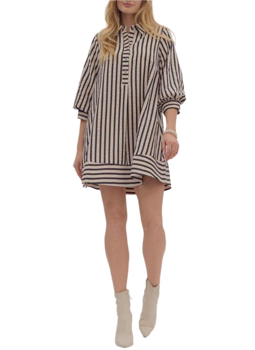 Striped seersucker pullover mini dress featuring button closure cuff 3/4 bubble sleeve. Collared half button front closure. Pockets at side. Lined. Woven. Non-sheer. Lightweight.