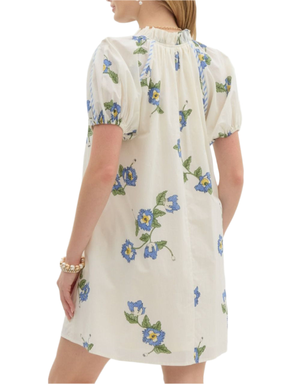 Floral print pullover swing mini dress featuring short puff sleeve accented with contrast seam binding. Pockets at side. Front button closure. Lined. Woven. Non-sheer. Lightweight.