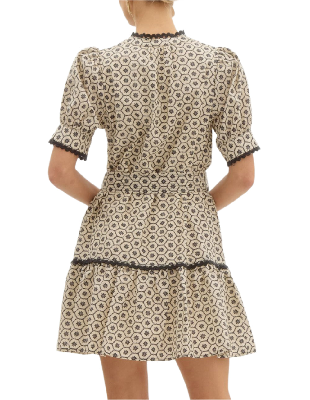 Printed short puff sleeve mini pullover dress featuring scallop trim accents at neck sleeve and skirt. Exposed stitch detail on adjustable waist tie. Pockets at side. Lined. Woven. Non-sheer. Lightweight.