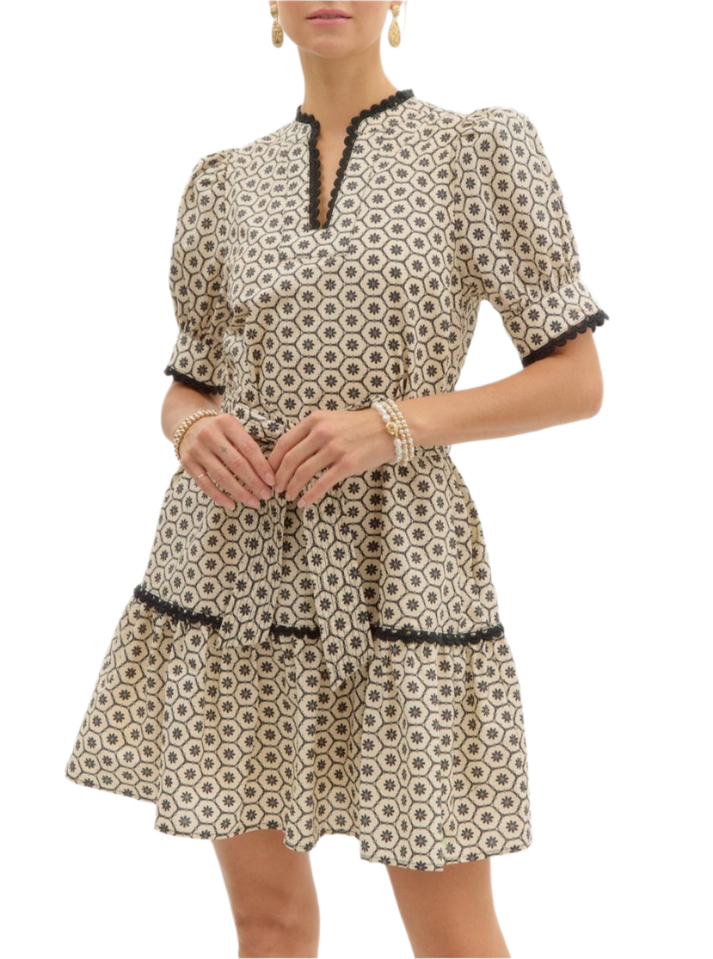 Printed short puff sleeve mini pullover dress featuring scallop trim accents at neck sleeve and skirt. Exposed stitch detail on adjustable waist tie. Pockets at side. Lined. Woven. Non-sheer. Lightweight.