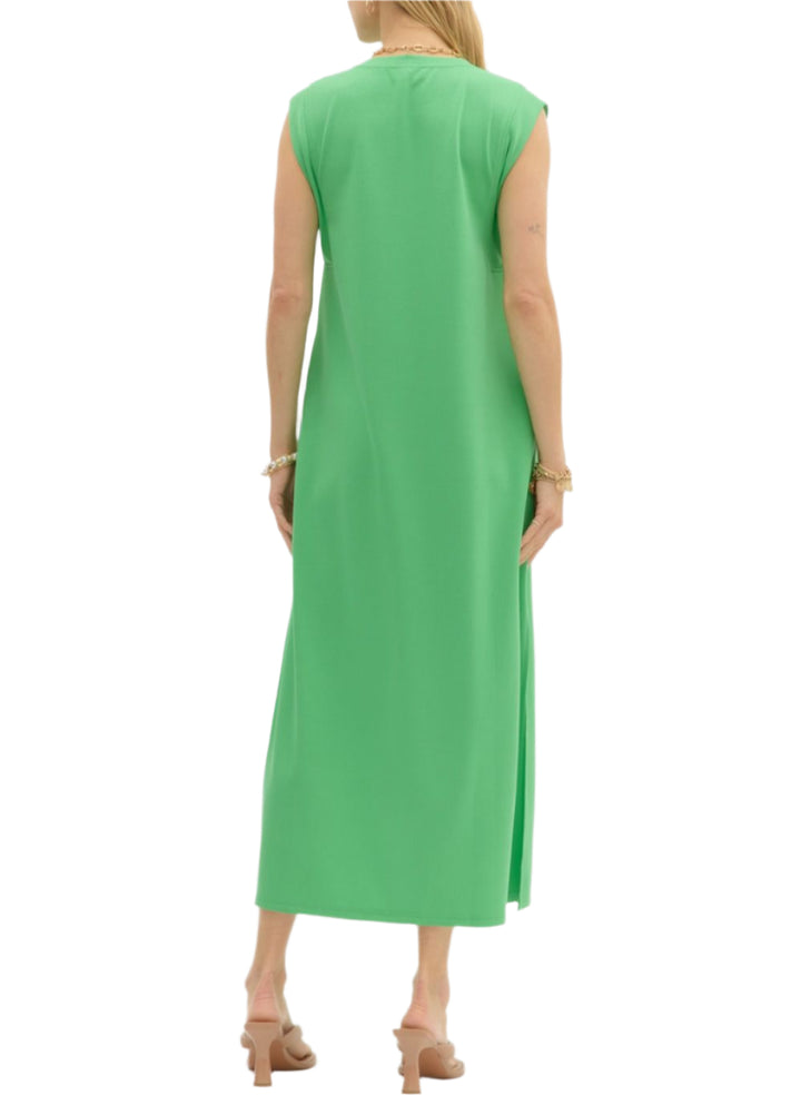 Solid jersey knit pullover midi dress featuring side slit hem. Pockets at sides. Unlined. Knit. Non-sheer. Lightweight.