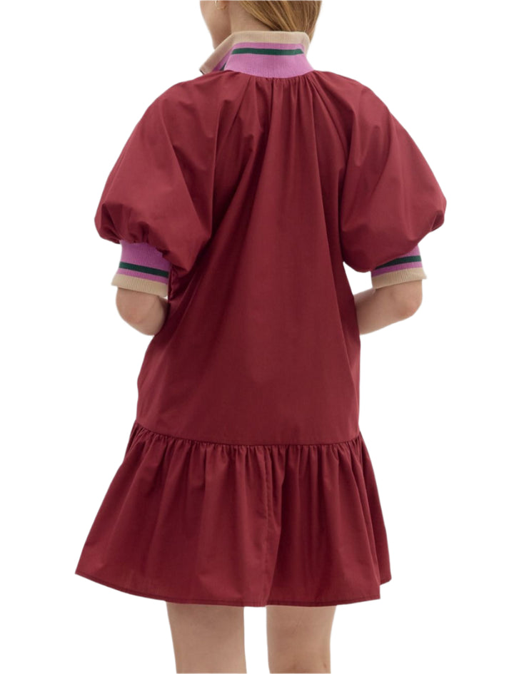 Solid puff sleeve ruffle hem mini dress featuring multicolor accent band and zipper closure at front neck. Pockets at sides. Lined. Woven. Non-sheer. Lightweight.