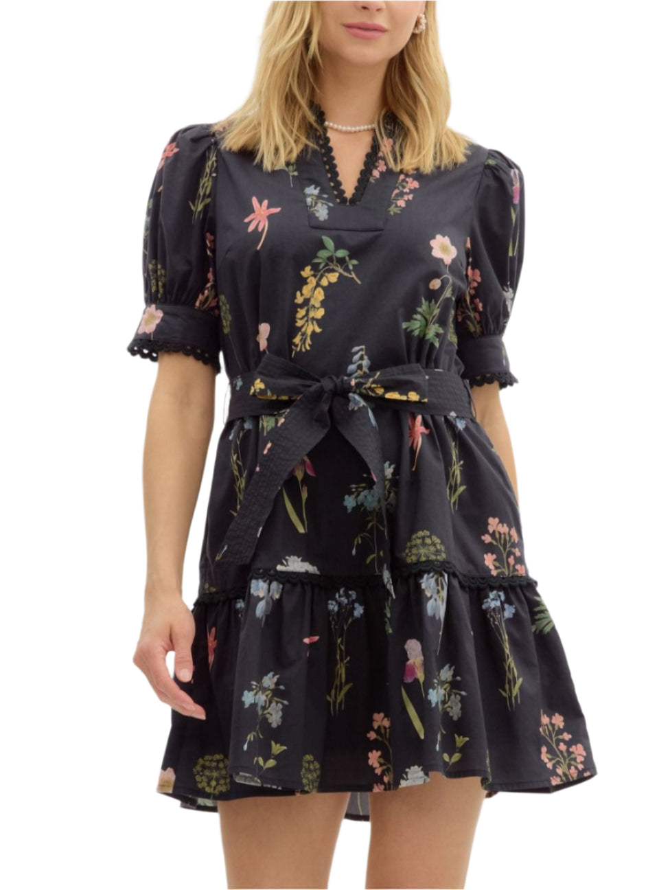 Floral print short puff sleeve mini pullover dress featuring scallop trim accents at neck sleeve and skirt. Removable self belt. Pockets at side. Lined. Woven. Non-sheer. Lightweight.