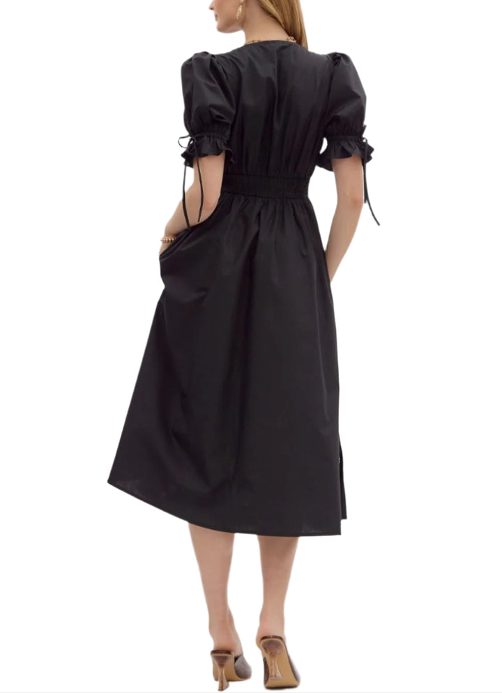 Solid short puff sleeve midi dress featuring stitch accent V-neck and waistband and embroidered skirt hem. Zipper front closure with smocked waistband at back. Lined. Woven. Non-sheer. Lightweight.