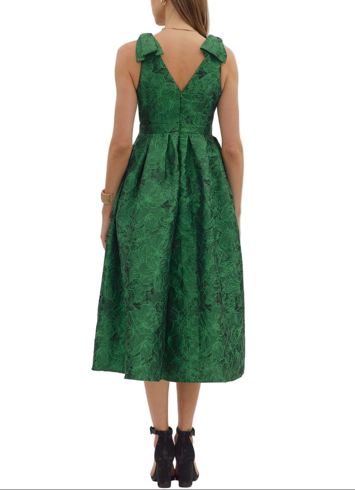 Floral jacquard sleeveless midi dress featuring bow accent at shoulder straps and pleated skirt. Zip closure at back. Side pockets. Unlined. Woven. Non-sheer. Lightweight.