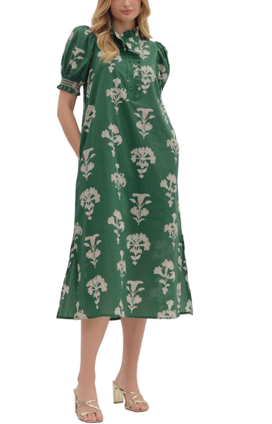 Botanical print short puff sleeve midi dress featuring ruffled neck and partial button closure at front. Side pockets. Lined. Woven. Non-sheer. Lightweight.
