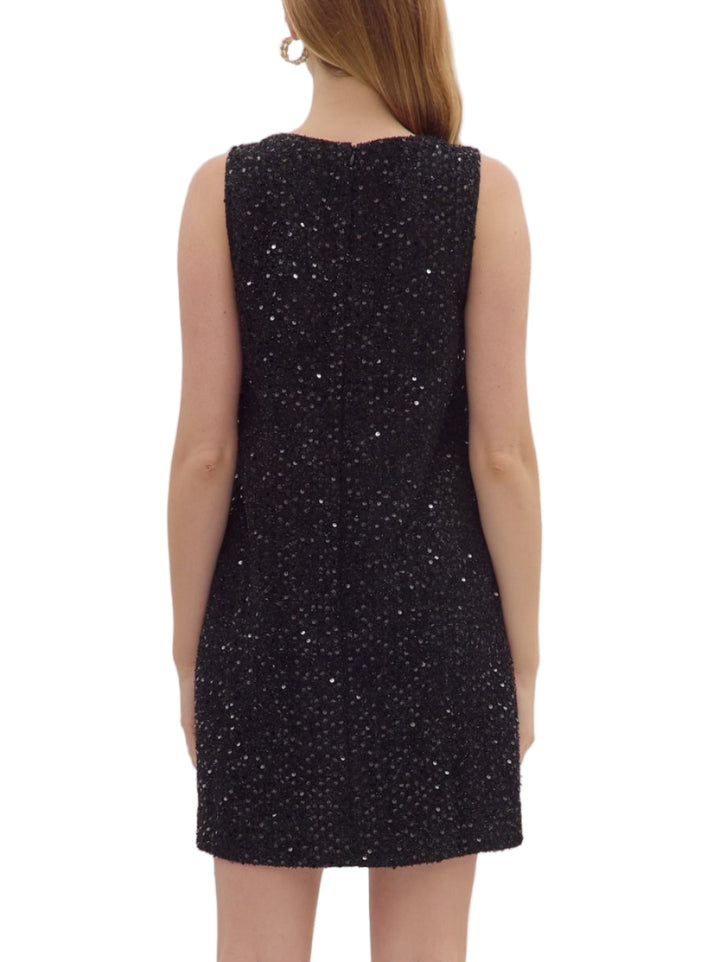 Sequin sleeveless mini dress featuring beaded neckline with front keyhole. Side pockets. Button closure at back. Lined. Woven. Non-sheer. Lightweight.

