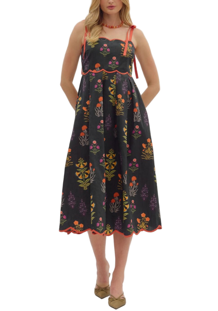 Floral print tie strap midi dress featuring scalloped straight neckline with binding detail and pleated waist. Smocked back. Side pockets. Lined. Woven. Non-sheer. Lightweight.