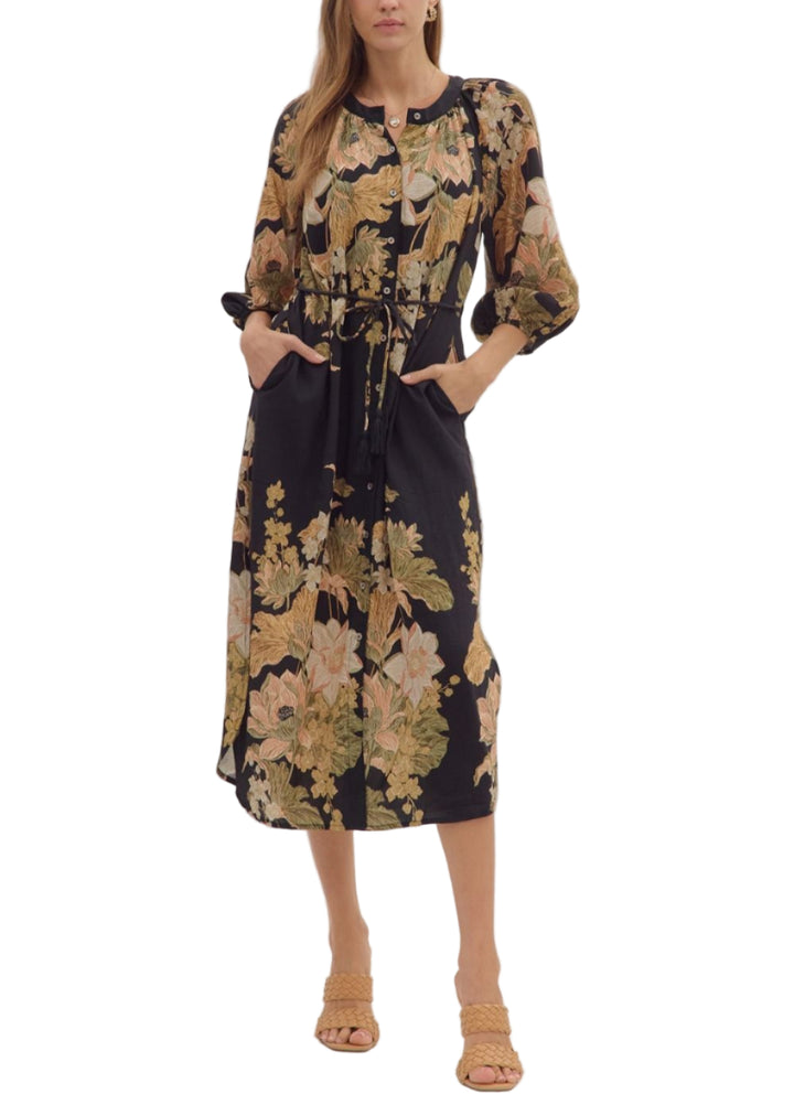 Floral print long sleeve midi dress featuring button closure at front and adjustable drawstring waist. Elasticated sleeve openings. Side pockets. Lined. Woven. Non-sheer. Lightweight.
