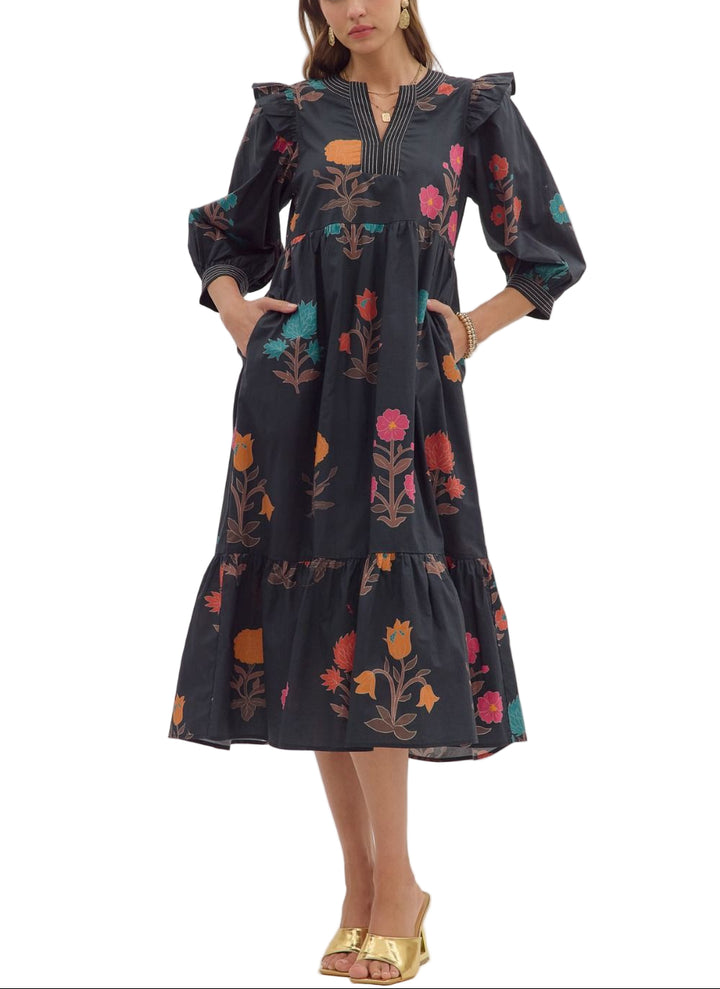 Floral print 3/4 puff sleeve midi dress featuring V-neck with contrast stitch detail and ruffle shoulder accents. Side pockets. Ruffle hem. Lined. Woven. Non-sheer. Lightweight.
