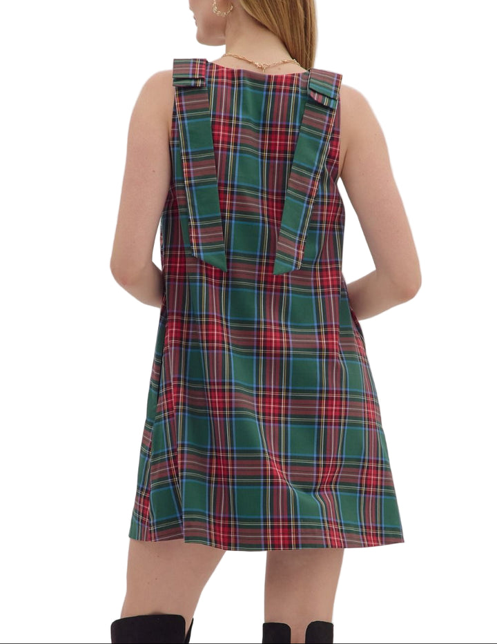 Plaid sleeveless mini dress featuring bow detail at straps. Side pockets. Lined. Woven. Non-sheer. Lightweight.