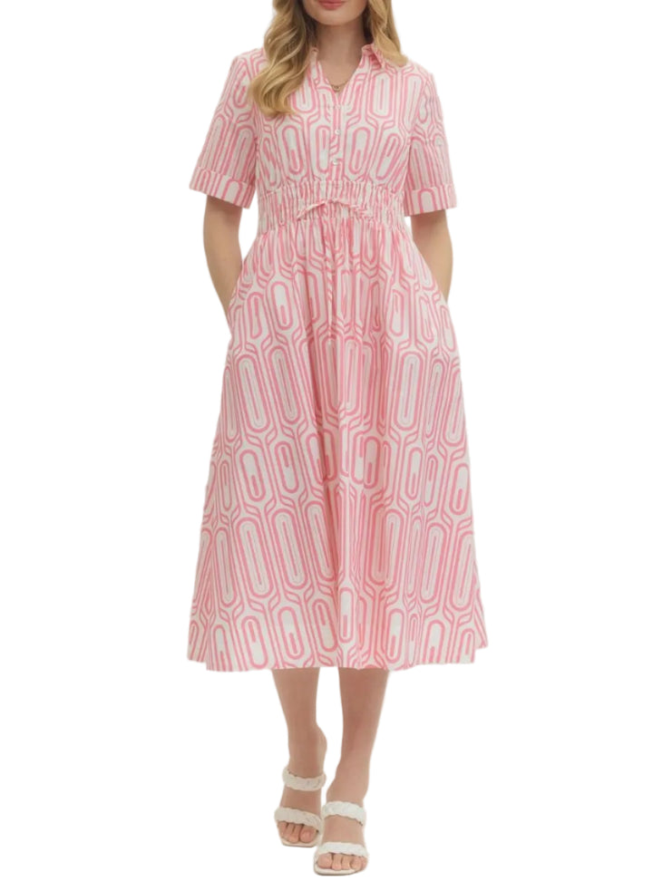 Geometric print short sleeve midi dress featuring elasticated waist detail and button closure at front. Side pockets. Lined. Woven. Non-sheer. Lightweight.
