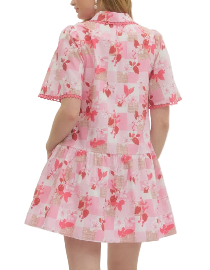 Solid floral short sleeve mini dress featuring pleated bib panel with scallop accent trim. Button closure at front. Side pockets. Unlined. Woven. Non-sheer. Lightweight.
