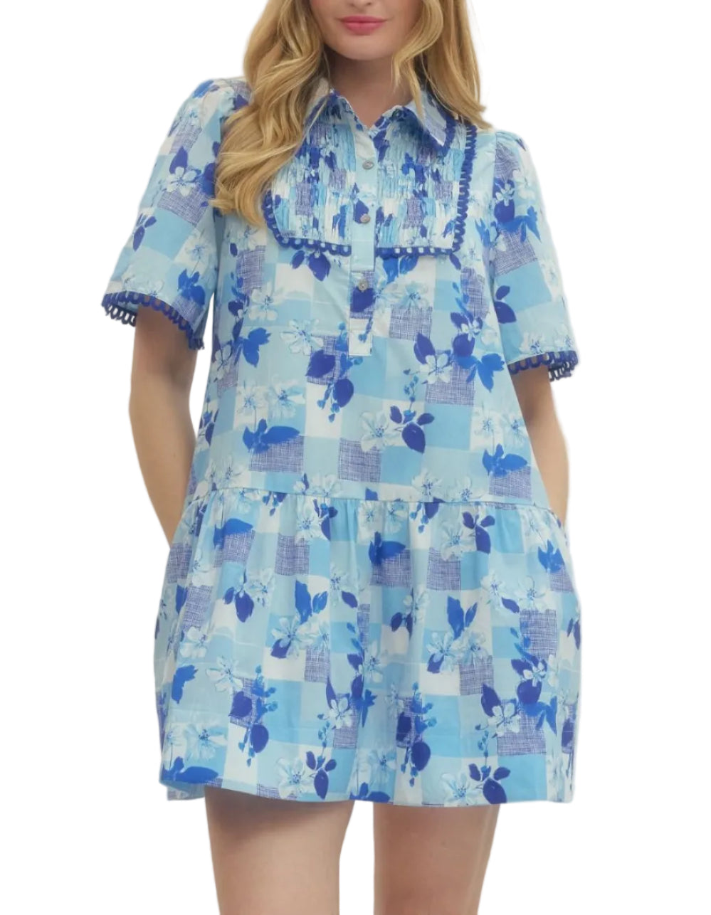 Solid floral short sleeve mini dress featuring pleated bib panel with scallop accent trim. Button closure at front. Side pockets. Unlined. Woven. Non-sheer. Lightweight.
