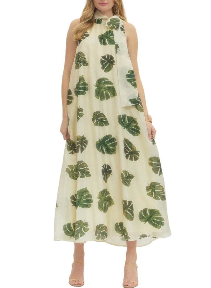 Leaf print halter neck maxi dress featuring self-tie detail at neck. Side pockets. Lined. Woven. Non-sheer. Lightweight.
