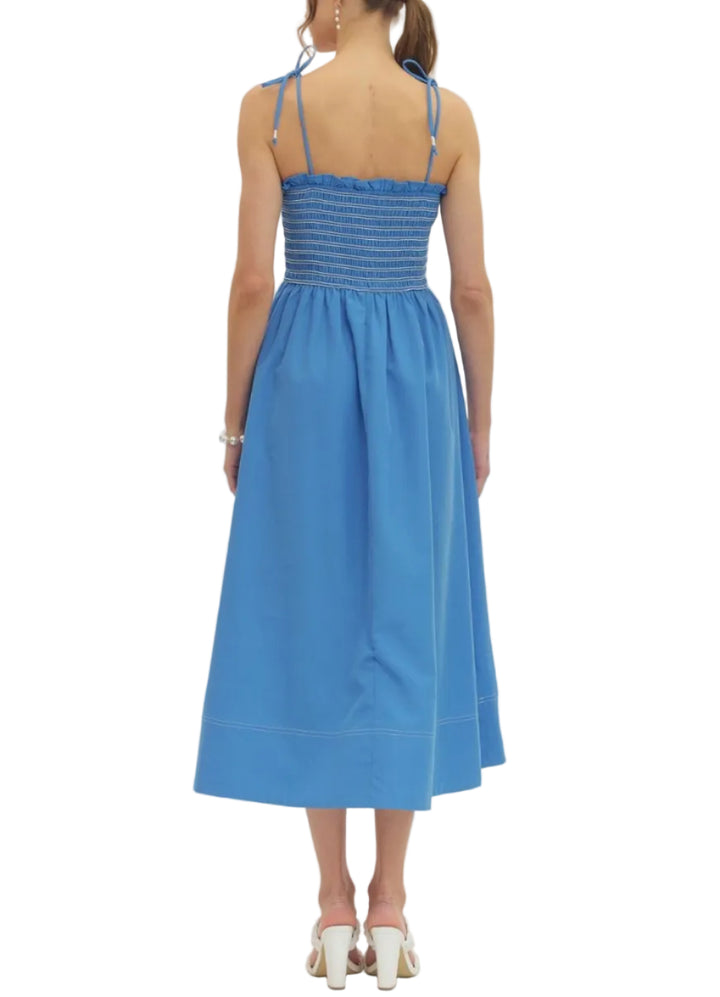 Solid sleeveless midi dress featuring smocked bodice. Tie shoulder straps. Side pockets. Lined. Woven. Non-sheer. Lightweight.

