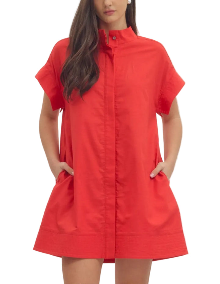 Solid short sleeve mini dress featuring hidden button placket. Side pockets. Lined. Woven. Non-sheer. Lightweight.