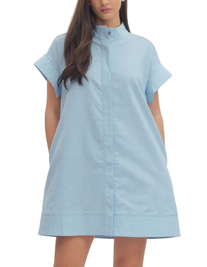 Solid short sleeve mini dress featuring hidden button placket. Side pockets. Lined. Woven. Non-sheer. Lightweight.