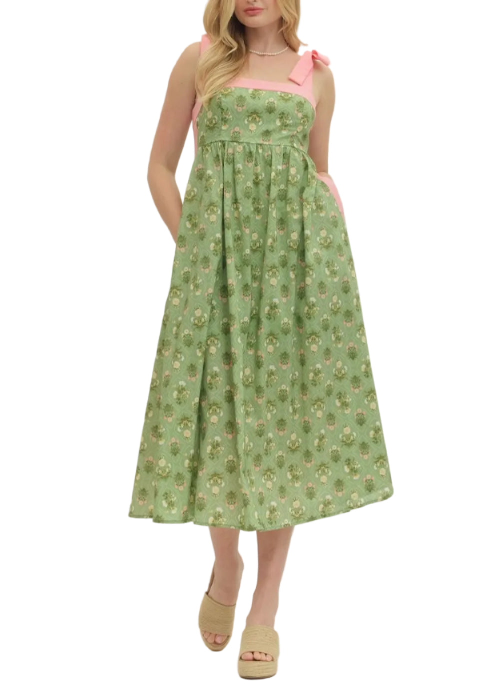 Botanical print sleeveless midi dress featuring shoulder tie straps. Square neckline. Side pockets. Smocked back. Lined. Woven. Non-sheer. Lightweight.
