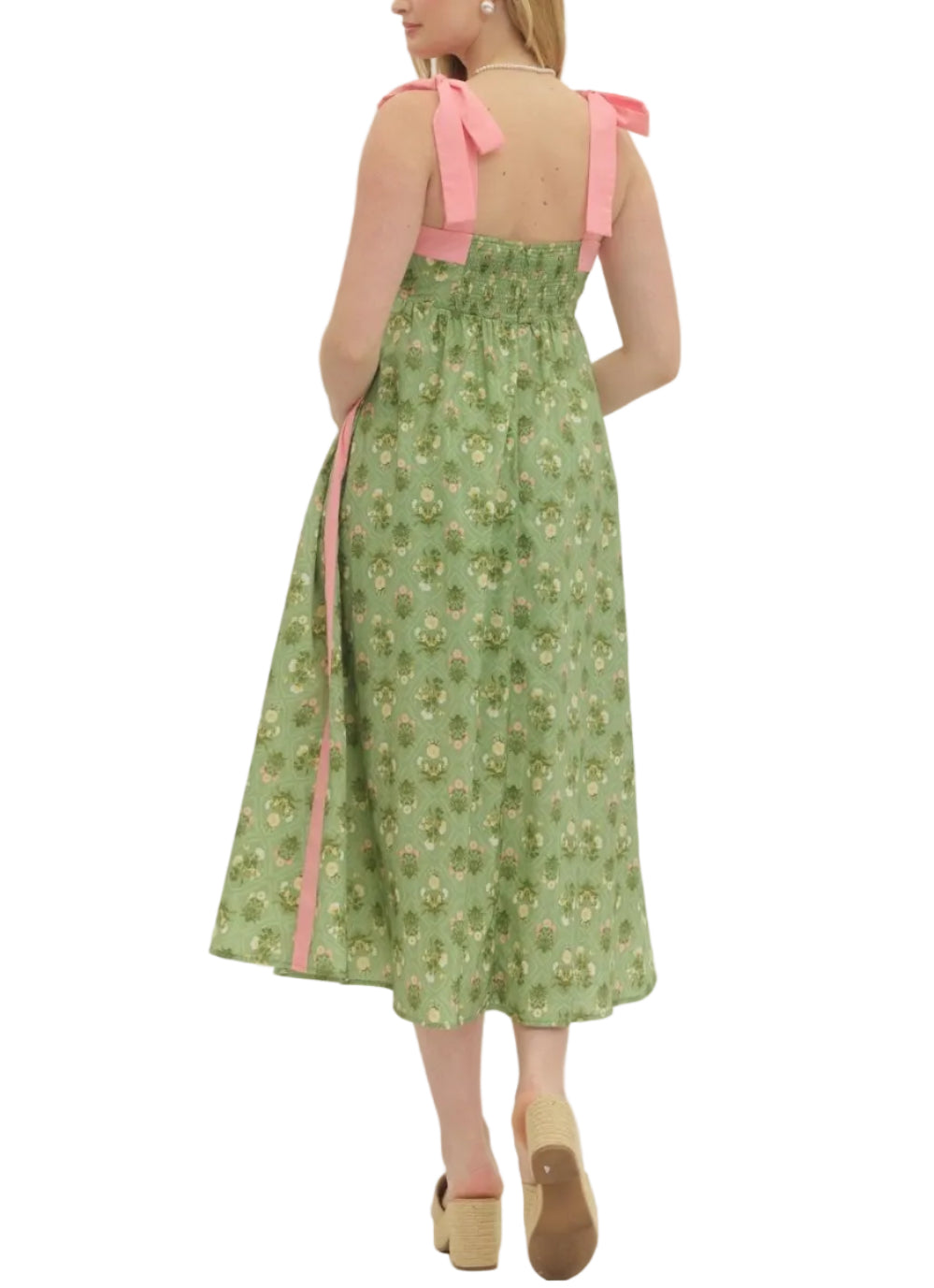 Botanical print sleeveless midi dress featuring shoulder tie straps. Square neckline. Side pockets. Smocked back. Lined. Woven. Non-sheer. Lightweight.
