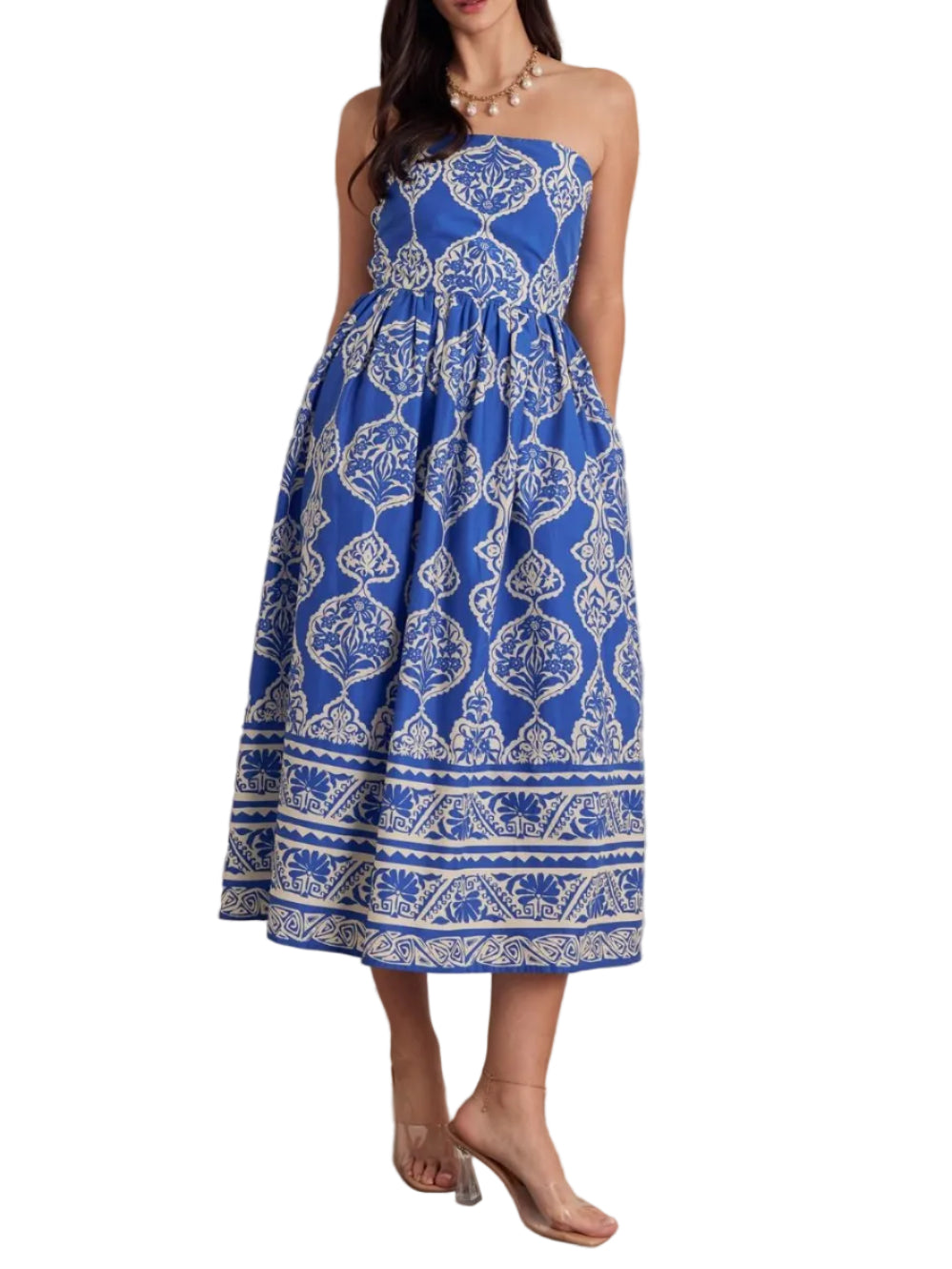 Printed strapless midi dress featuring smocked back bodice. Side pockets. Back zipper closure. Lined. Woven. Non-sheer. Lightweight.
