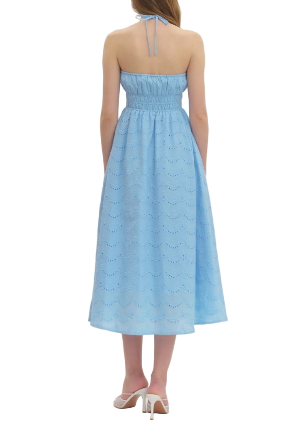 Solid halter midi dress featuring eyelet pattern and smocked waist. Self-tie halter at back neck. Side pockets. Lined. Woven. Non-sheer. Lightweight.
