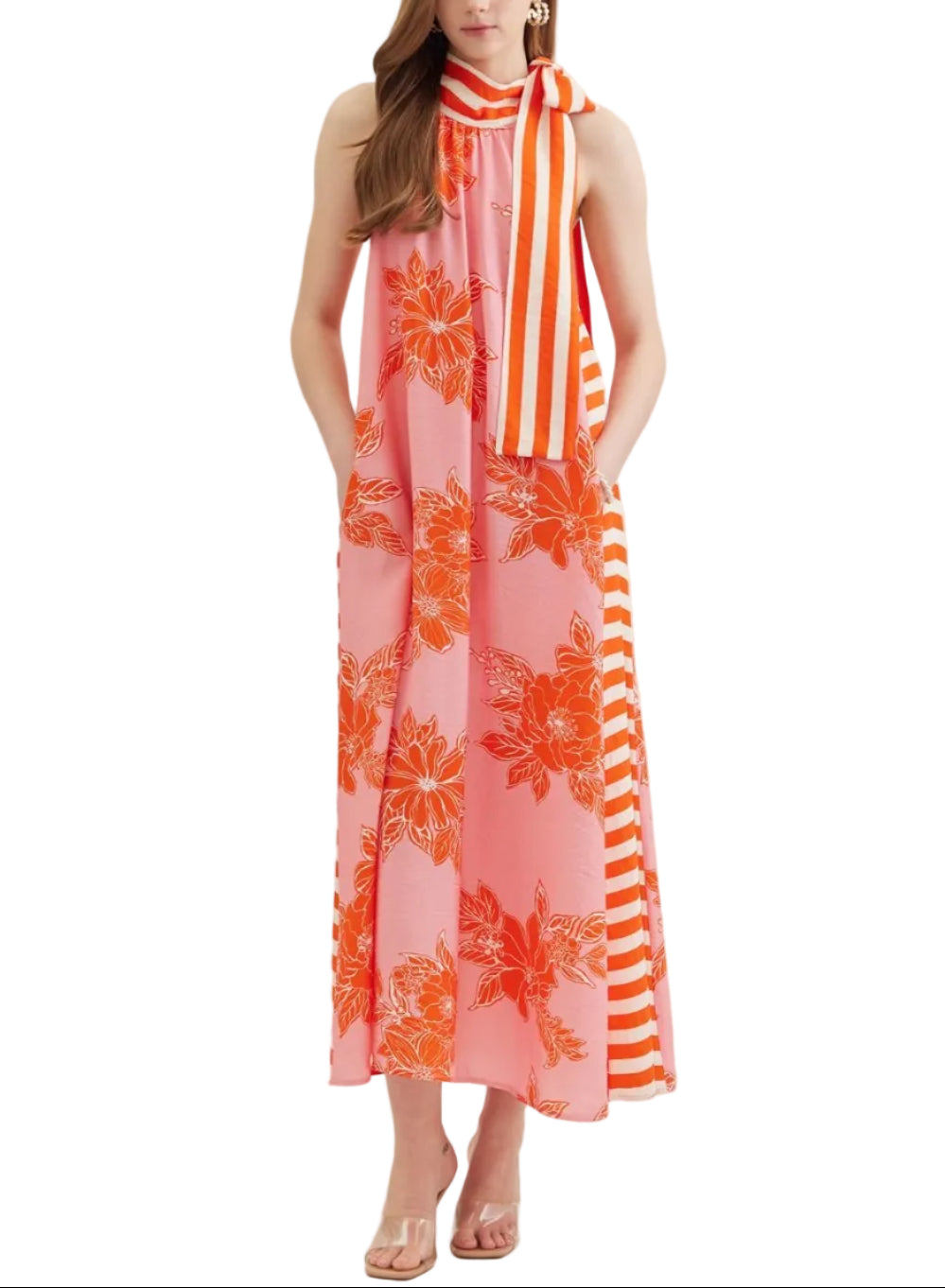 Botanical print sleeveless midi dress featuring contrast striped tie neck. Self tie closure at neck. Side pockets. Lined. Woven. Non-sheer. Lightweight.