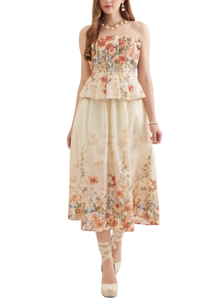 Floral print strapless midi dress featuring pleated peplum bodice. Zipper closure at back. Side pockets. Smocked back. Lined. Woven. Non-sheer. Lightweight.
