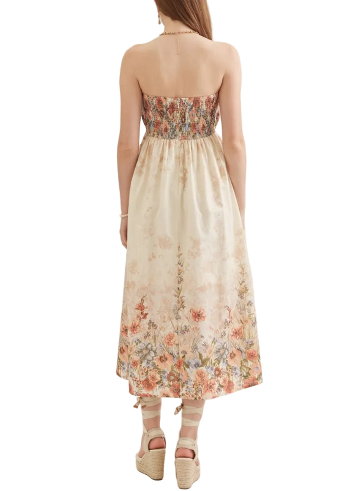 Floral print strapless midi dress featuring pleated peplum bodice. Zipper closure at back. Side pockets. Smocked back. Lined. Woven. Non-sheer. Lightweight.
