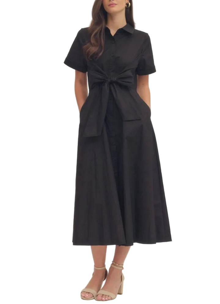 Solid short sleeve midi dress featuring collar and button closure at front. Self-tie bow detail at waist. Side pockets. Elasticated waist at back. Lined. Woven. Non-sheer. Lightweight.

