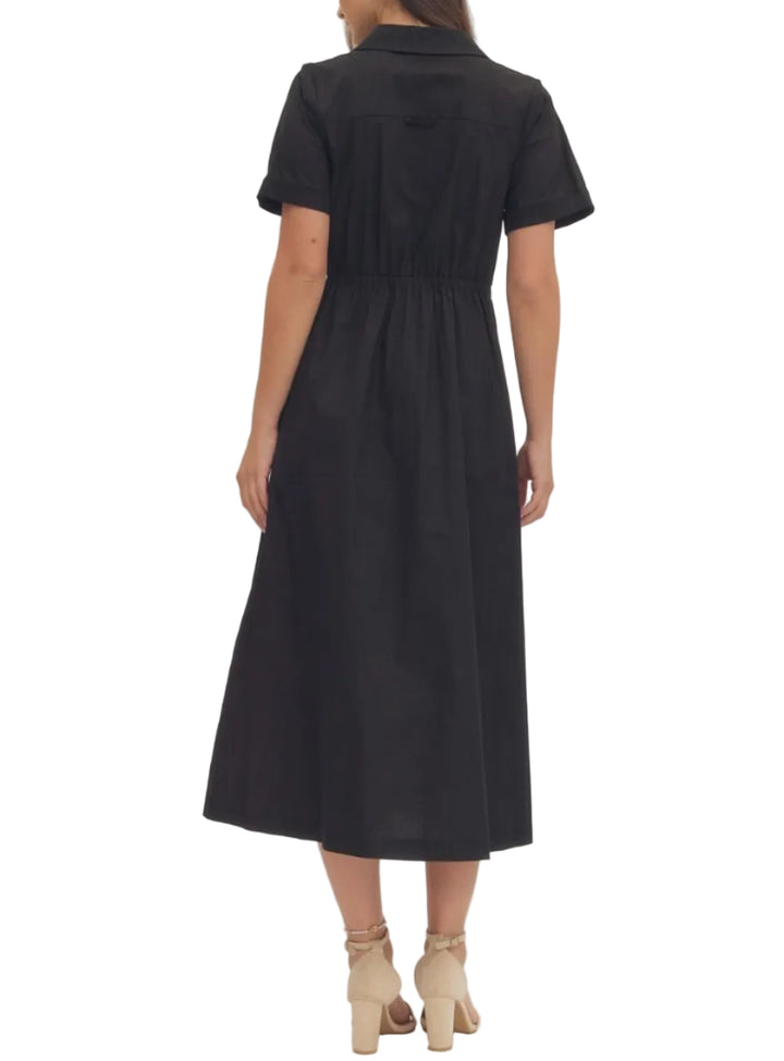 Solid short sleeve midi dress featuring collar and button closure at front. Self-tie bow detail at waist. Side pockets. Elasticated waist at back. Lined. Woven. Non-sheer. Lightweight.
