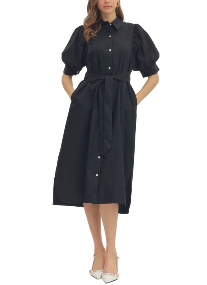 Solid short puff sleeve midi dress featuring shirt collar. Button closure at front. Self-tie waist belt. Side pockets. Curved high-low hem. Lined. Woven. Non-sheer. Lightweight.