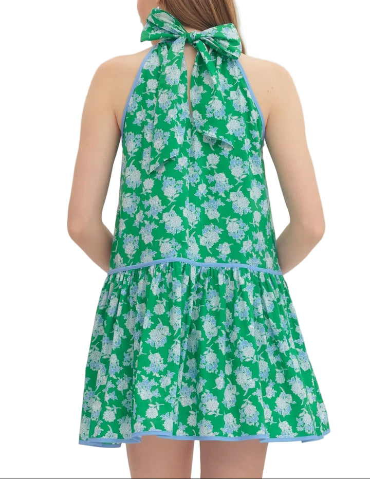 Floral print sleeveless mini dress featuring self-tie halter neckline. Drop waist seam. Contrast binding detail. Side pockets. Lined. Woven. Non-sheer. Lightweight.
