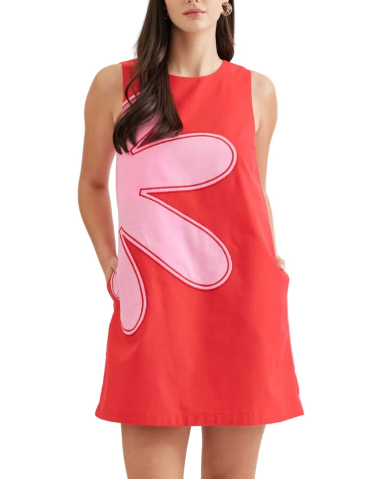 Effortless elegance meets practical design in this sleeveless mini dress. The solid silhouette is elevated by striking contrast appliqué detail, while a button closure at the back neck adds a refined touch. A convenient side zip and hidden side pockets make this piece as functional as it is stylish. Fully lined for comfort and crafted from lightweight woven fabric that moves with you.&amp;nbsp;
