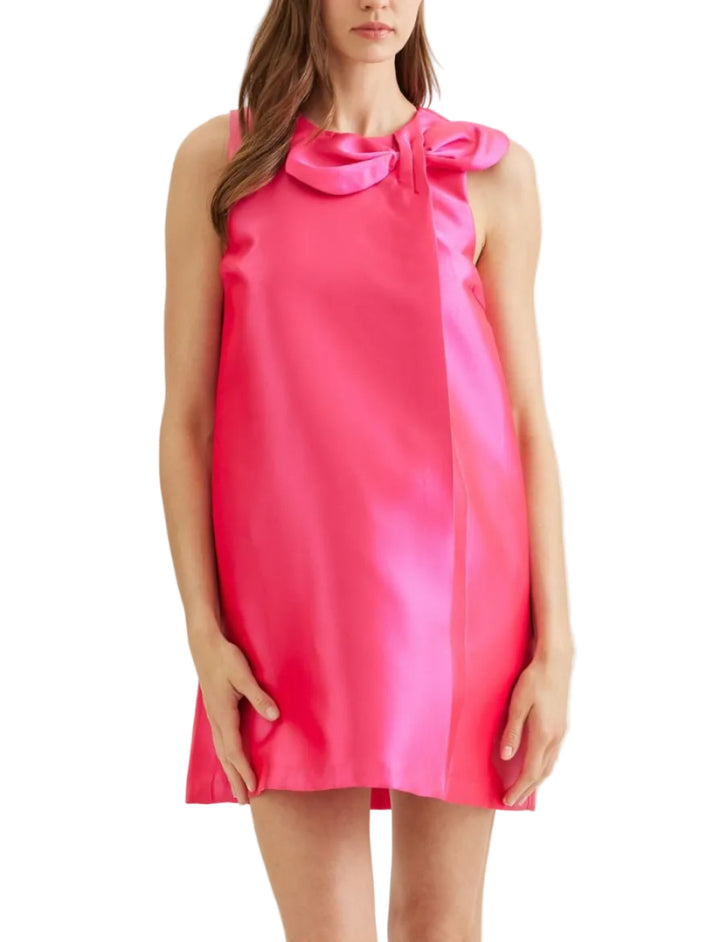 Solid sleeveless mini dress featuring twisted bow detail at neckline. Round neckline. Zipper closure at back. Side pockets. Lined. Woven. Non-sheer. Lightweight.
