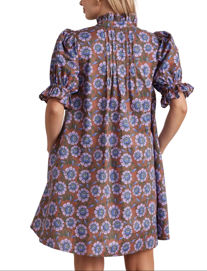 Floral print ruffled neck short puff sleeve mini dress featuring pleated front detail. Button closure at front. Side pockets. Lined. Woven. Non-sheer. Lightweight.