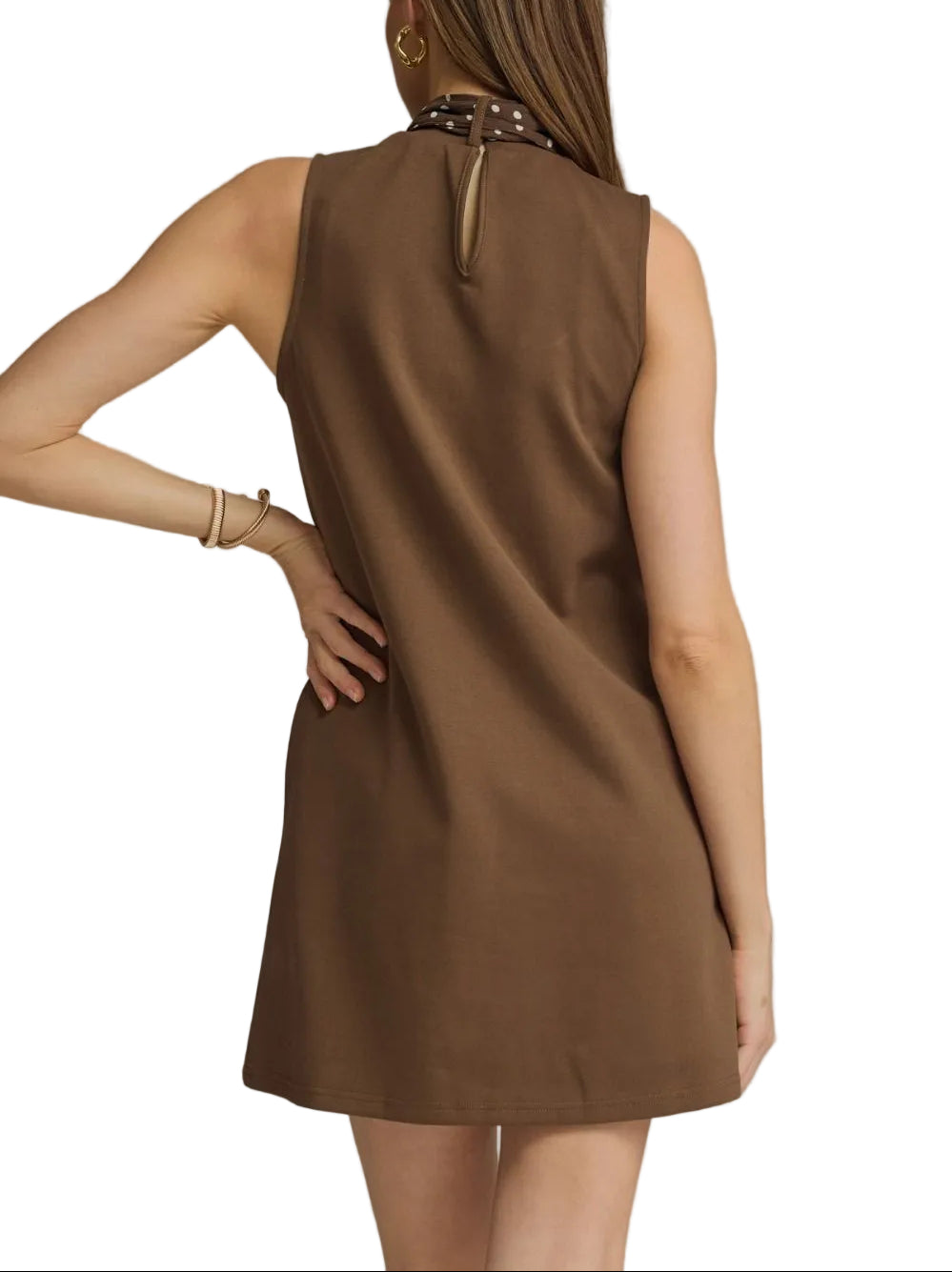The Isla Sleeveless Mini Dress combines effortless elegance with versatile styling. This lightweight piece features a flattering sleeveless silhouette perfect for warm weather, paired with an attached self-tie neck scarf that lets you customize your look. Wear the scarf tied at the neck for a polished finish, or drape it loosely for a relaxed vibe. Ideal for casual outings, weekend brunches, or layered styling. The mini length offers a modern, playful cut that works year-round with the right accessories.