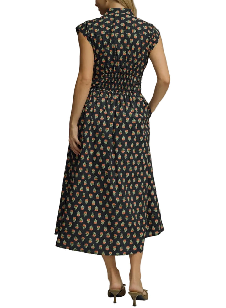 Geo print sleeveless midi dress featuring elasticated waist with self-tie detail. Button closure at front. Side pockets. Lined. Woven. Non-sheer. Lightweight.