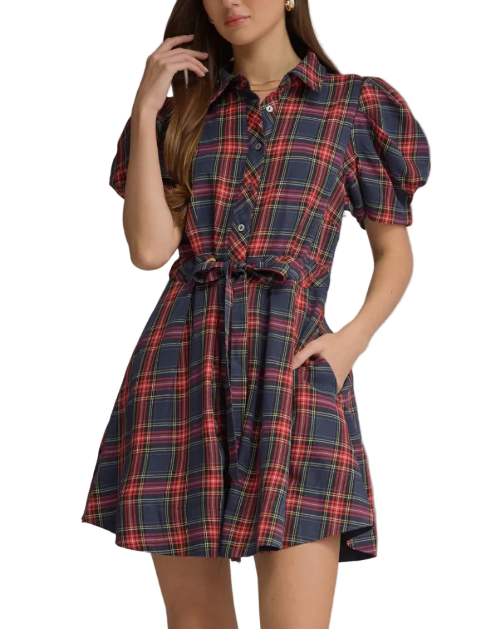 A woman modeling a short puff-sleeve plaid shirt dress with a tie waist and button front, shown against a plain gray studio background.
