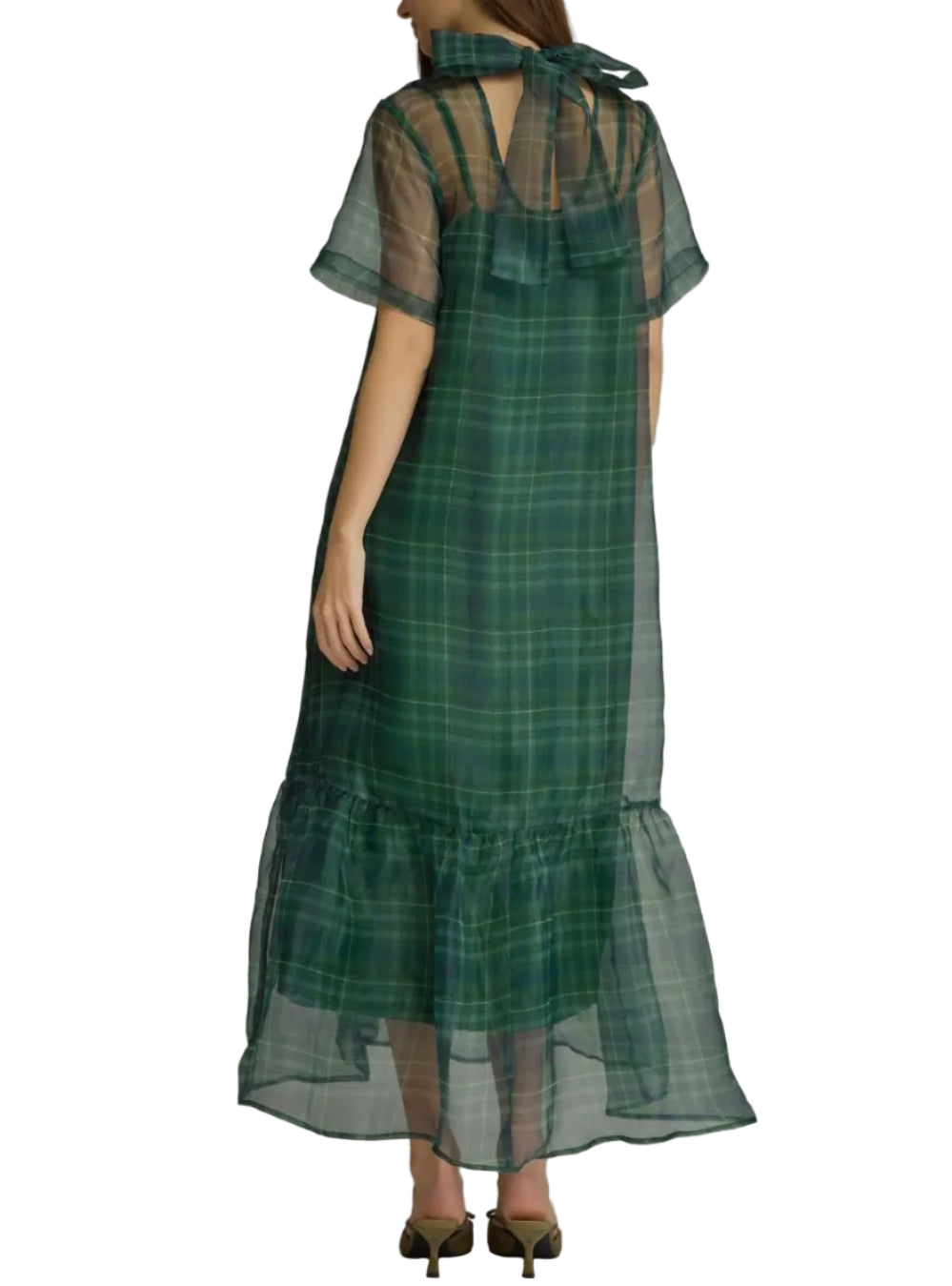 A woman modeling a sheer green plaid maxi dress with short flutter sleeves, a high neck with a bow, and a ruffled hem, shown from the back against a neutral gray studio background.
