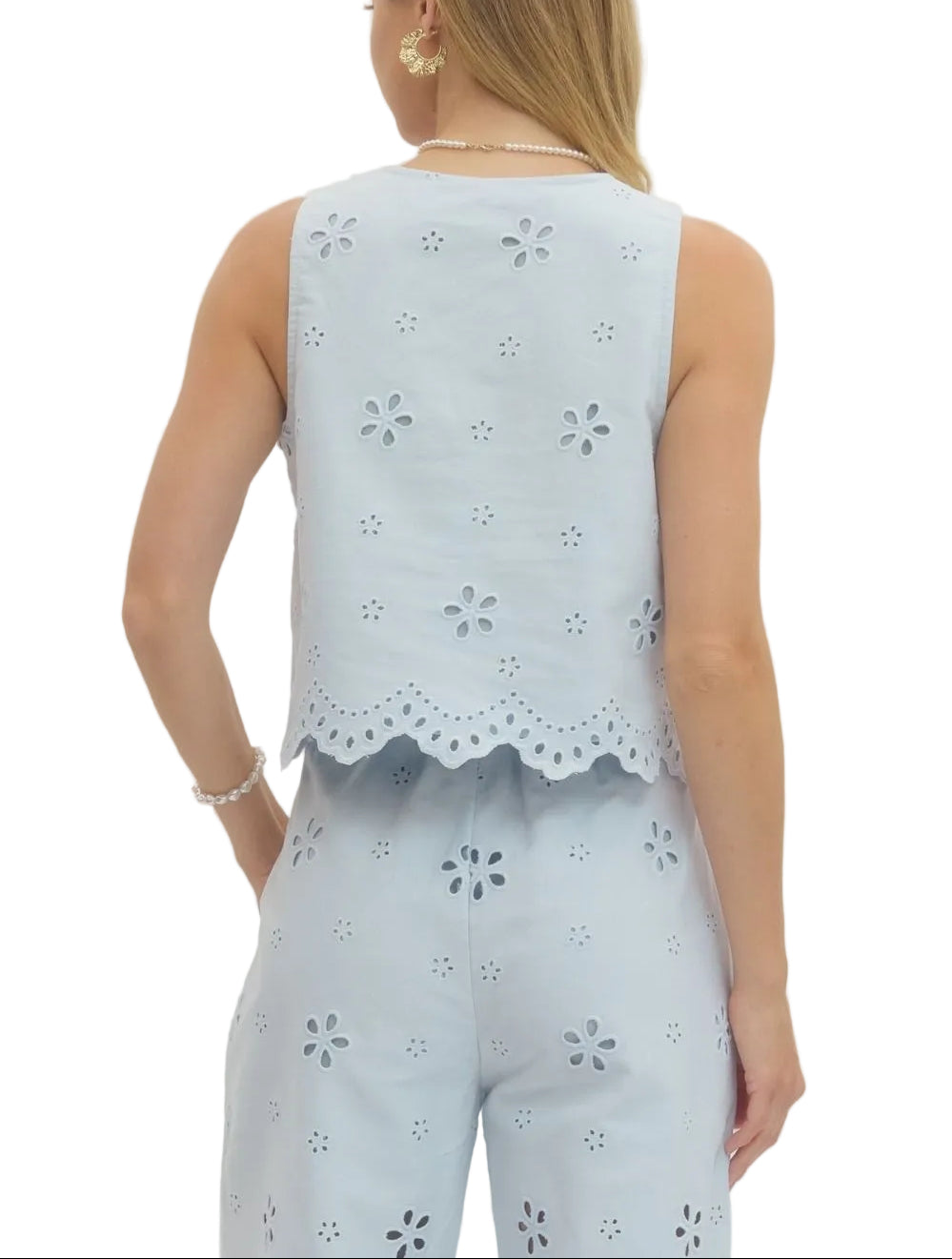 Effortlessly chic and undeniably fun, this eyelet embroidered sleeveless crop top/pant set brings a touch of vintage charm to your everyday wardrobe. The delicate eyelet detailing adds texture and visual interest, while the scallop hem creates a flirty, feminine finish.&nbsp;