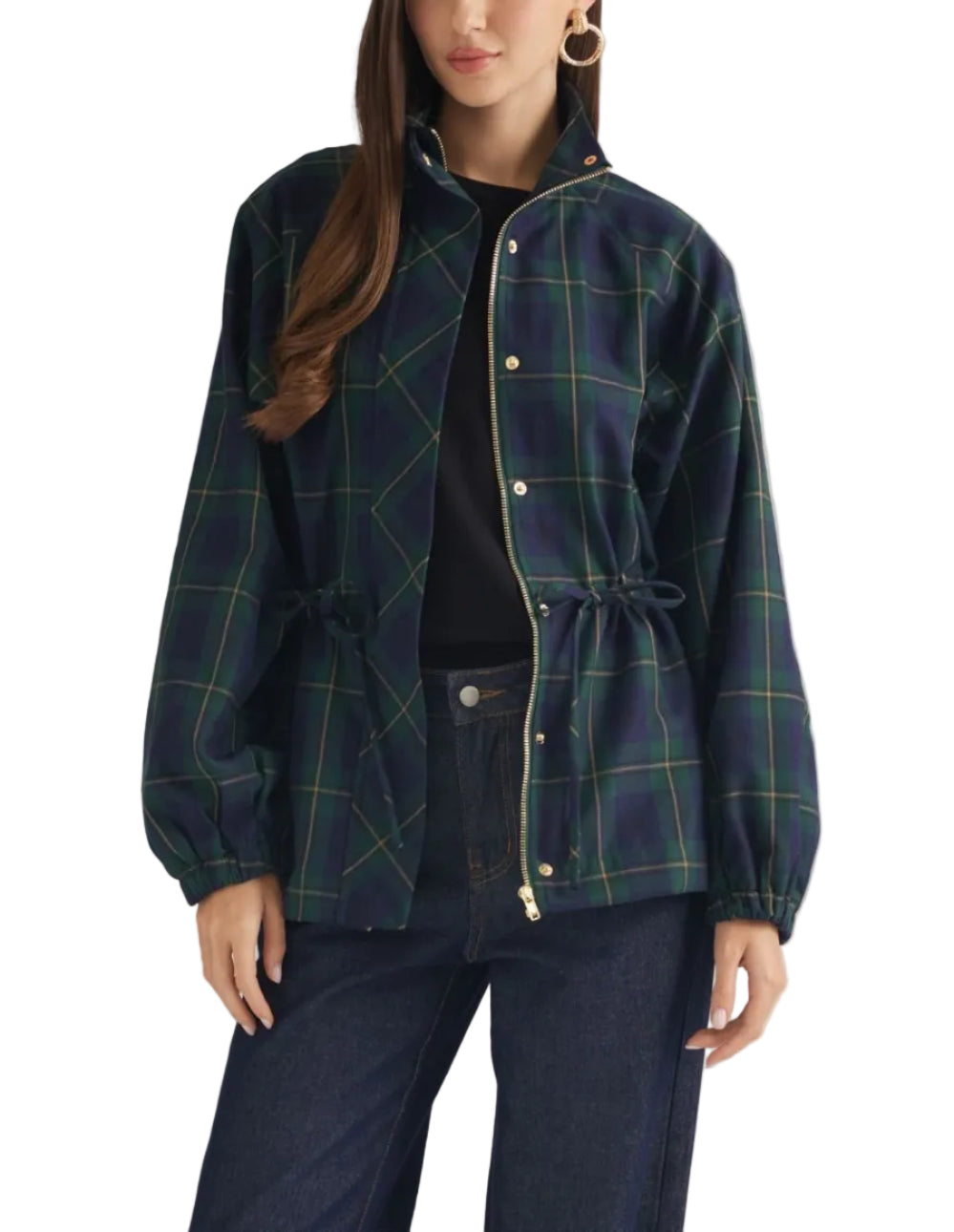 A woman models a navy blue plaid jacket with green and yellow lines, featuring a drawstring waist and gold-tone snap buttons, paired with dark jeans against a neutral studio background.
