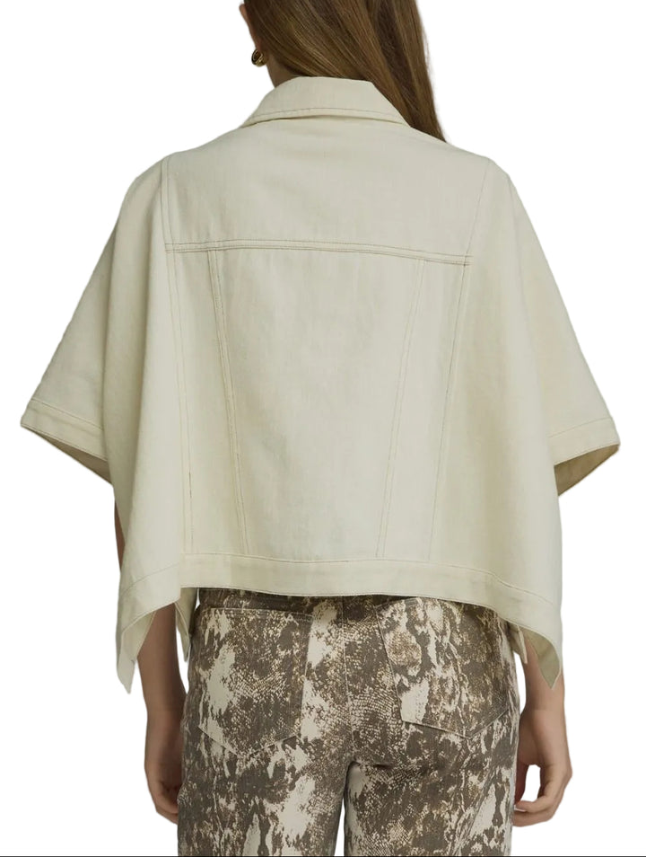 Solid denim short sleeve jacket featuring a snap button closure at front and chest pockets. Front pockets. Snap button closures at sides. Unlined. Woven. Non-sheer. Medium weight.