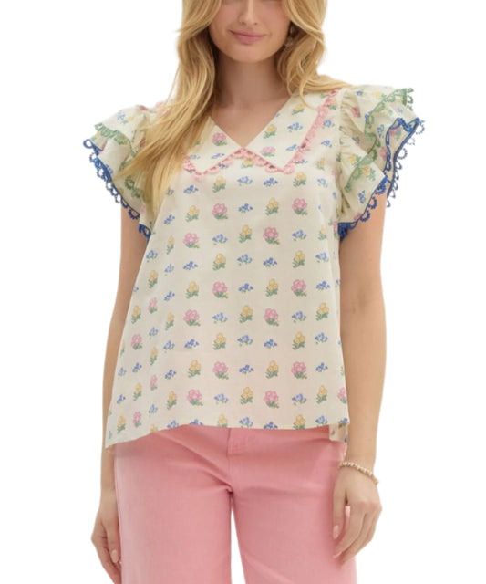 Floral print chelsea collar pullover top featuring double layer ruffle shoulder accented with multicolor scallop trim. Back neck button & keyhole closure. Unlined. Woven. Non-sheer. Lightweight.