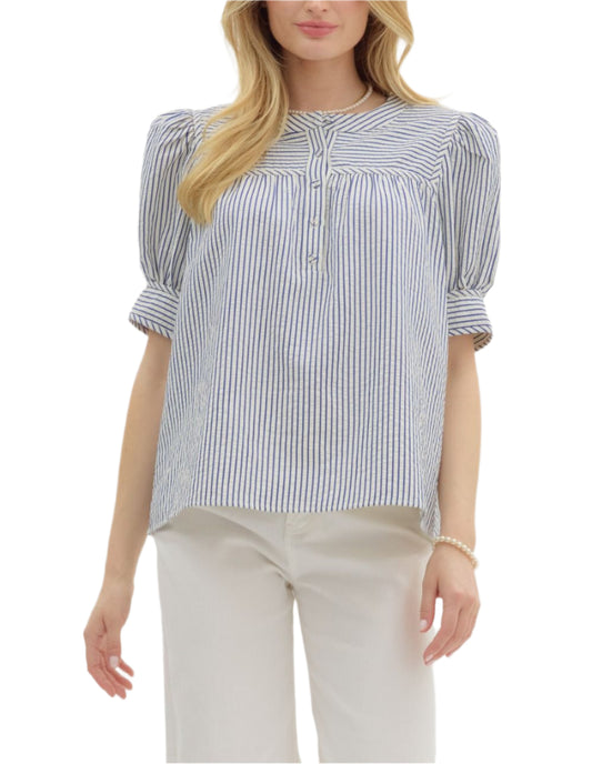 Stripe pattern structured shoulder short sleeve pullover top featuring bow tie closure cuff band. Button front closure. Unlined. Woven. Non-sheer. Lightweight.