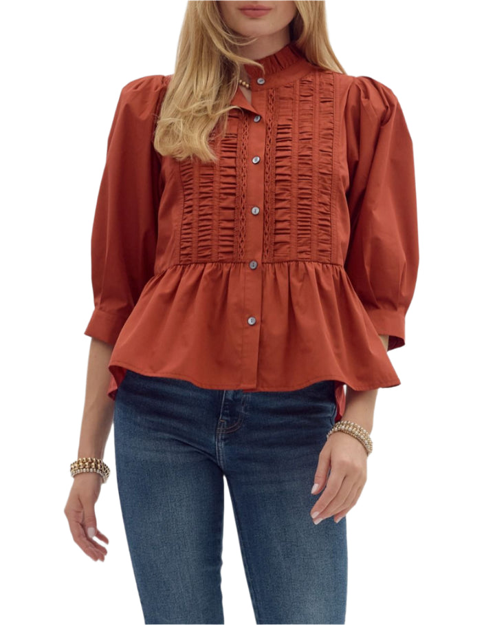 Solid cuff ¾ sleeve ruffle hem high neck button closure top featuring ruching accent detail. Unlined. Woven. Non-sheer. Lightweight.