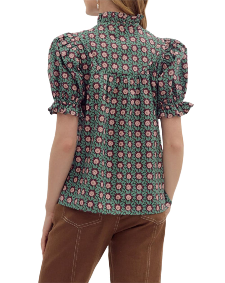 Floral pattern ruffle edge puff short sleeve V-neck pullover top. Unlined. Woven. Non-sheer. Lightweight.