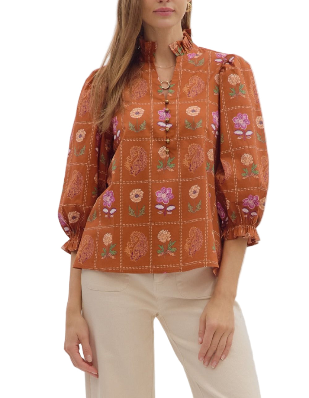 Floral and paisley print 3/4 puff sleeve top featuring ruffled high neck and loop button closure at front. Elasticated sleeve openings with ruffle trim. Unlined. Woven. Non-sheer. Lightweight.
