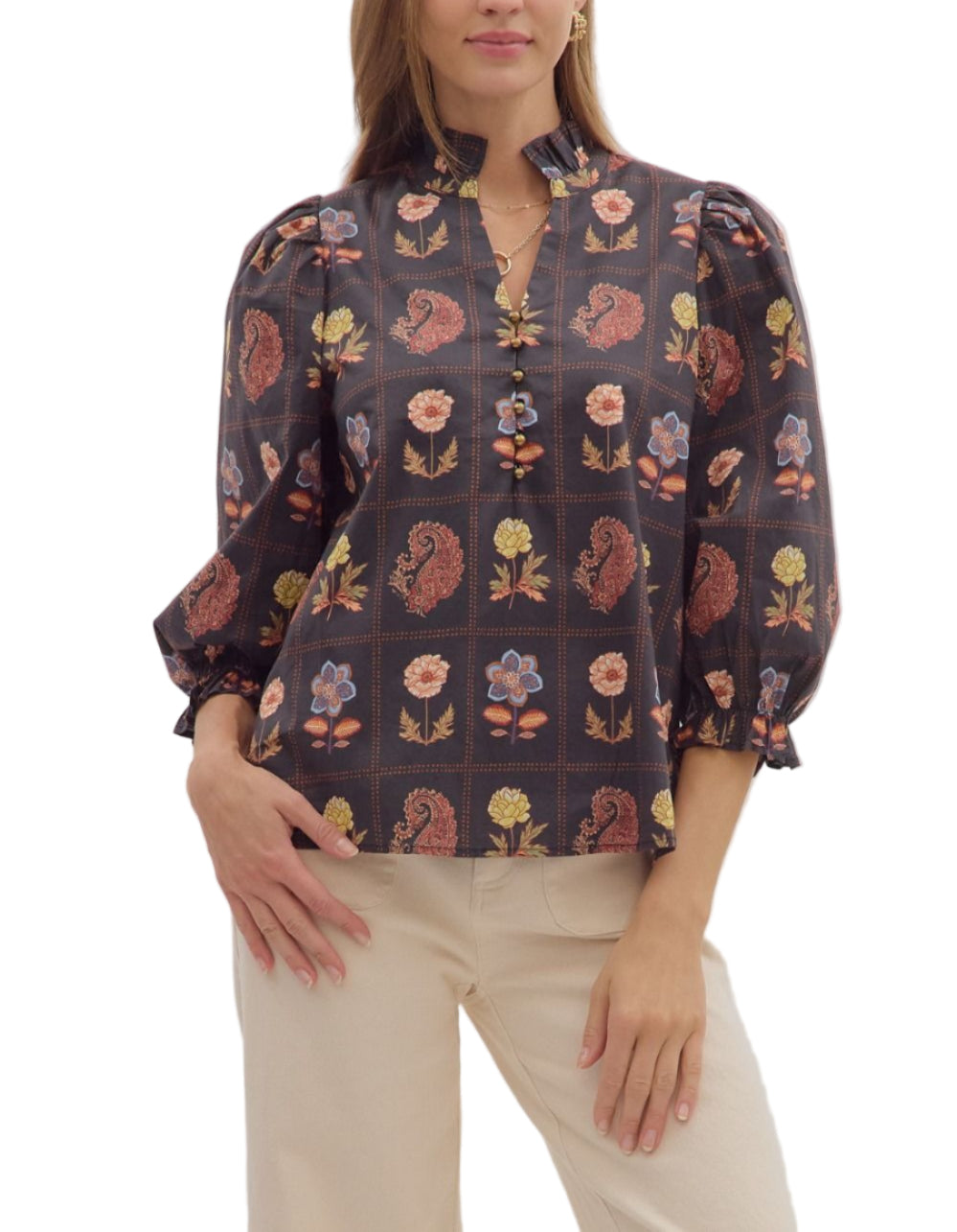 Floral and paisley print 3/4 puff sleeve top featuring ruffled high neck and loop button closure at front. Elasticated sleeve openings with ruffle trim. Unlined. Woven. Non-sheer. Lightweight.
